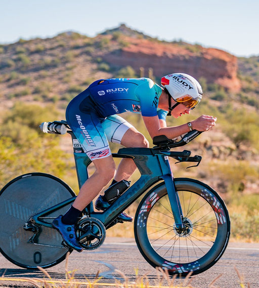 Athlete on the bike racing in a custom racesuit